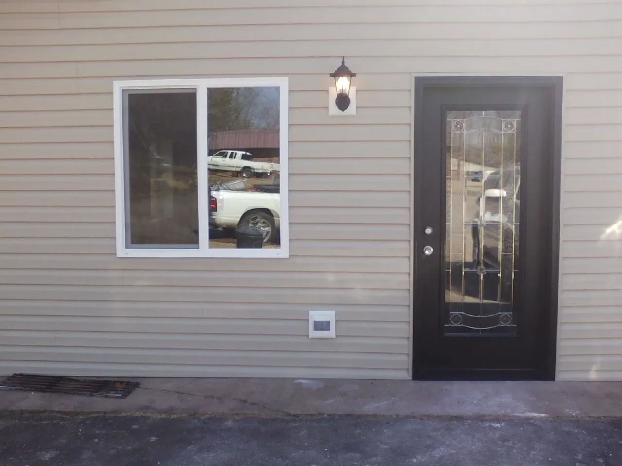 New siding, window and entry door on the side of an addition in Pedricktown