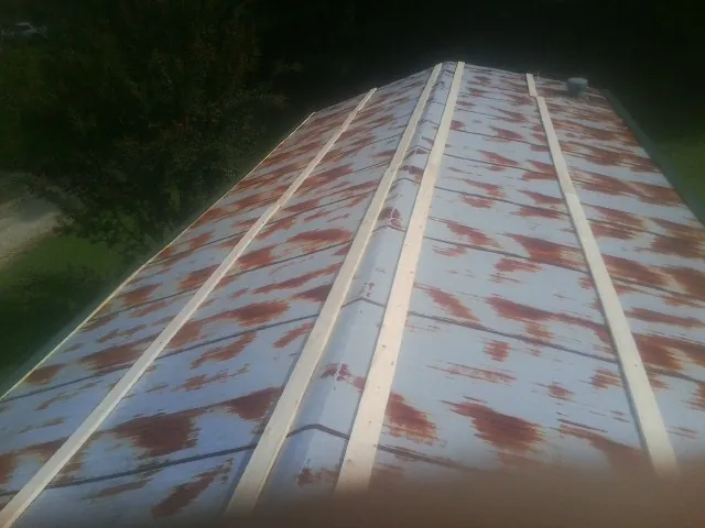 Rusted metal roof panels with new wood purlins before replacement — Storm Damage Roof Repair in Pedricktown by Roofing Brothers